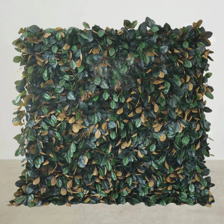 Dense artificial foliage flower wall backdrop with green and brown leaves