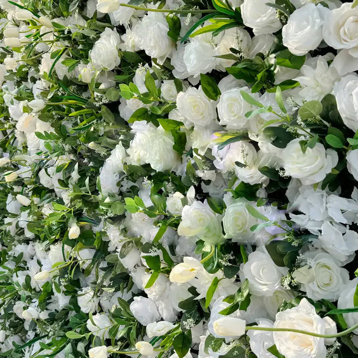 Detailed view of wedding floral backdrop with white blooms and green leaves