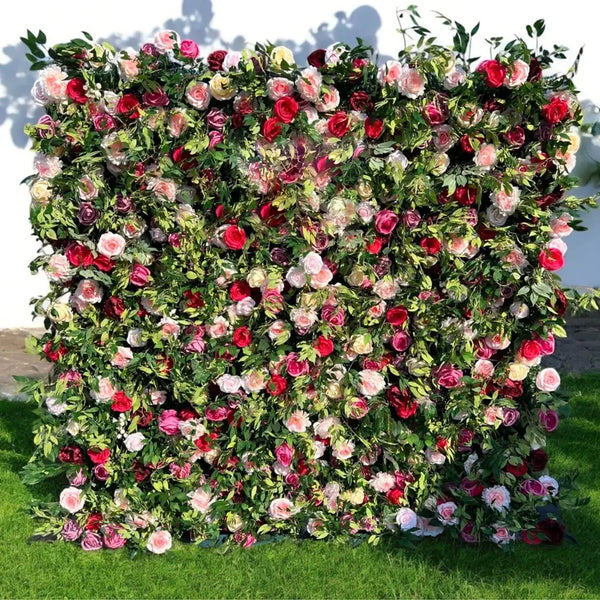 Lush flower wall backdrop with red, pink, and ivory roses and greenery