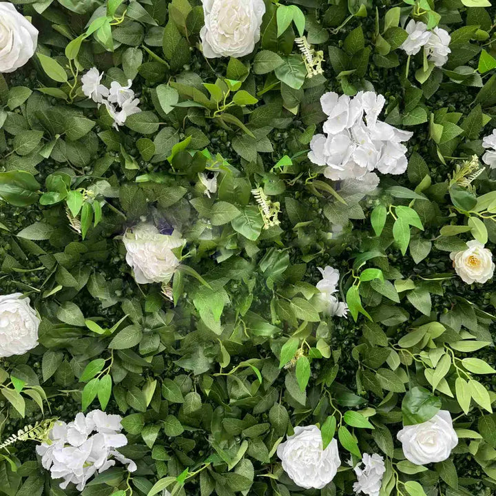 Detailed texture of flower wall featuring white blooms and lush greenery for decorative purposes.