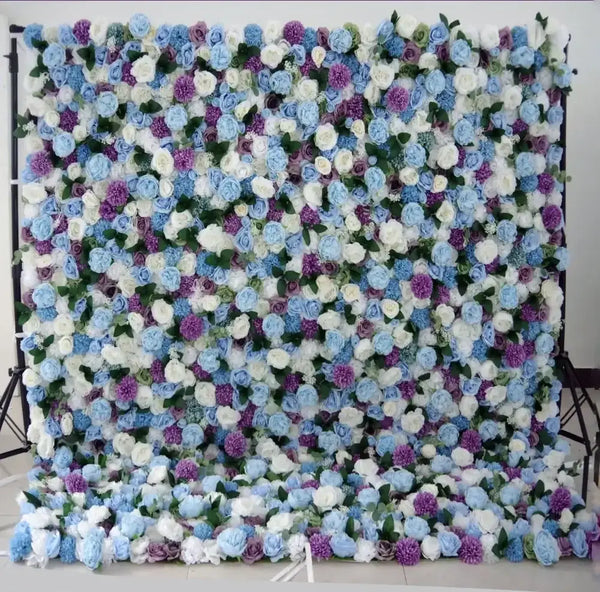Soft pastel blue and lavender flower wall backdrop with roses and greenery