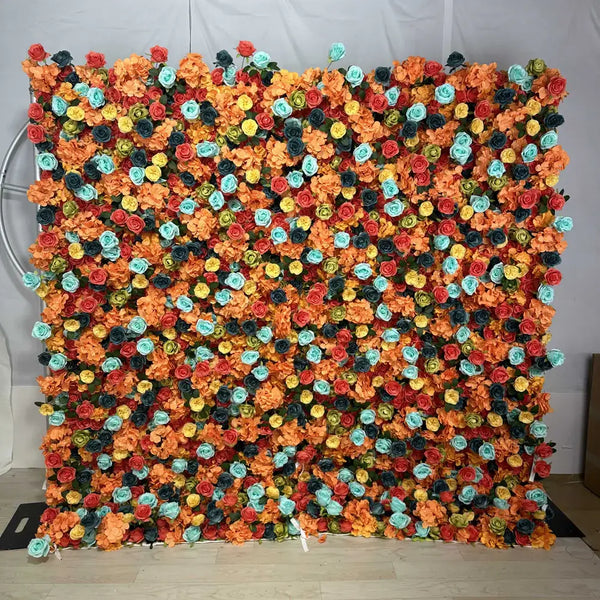 Bold flower wall with aqua, yellow, coral, navy, and orange roses for events.