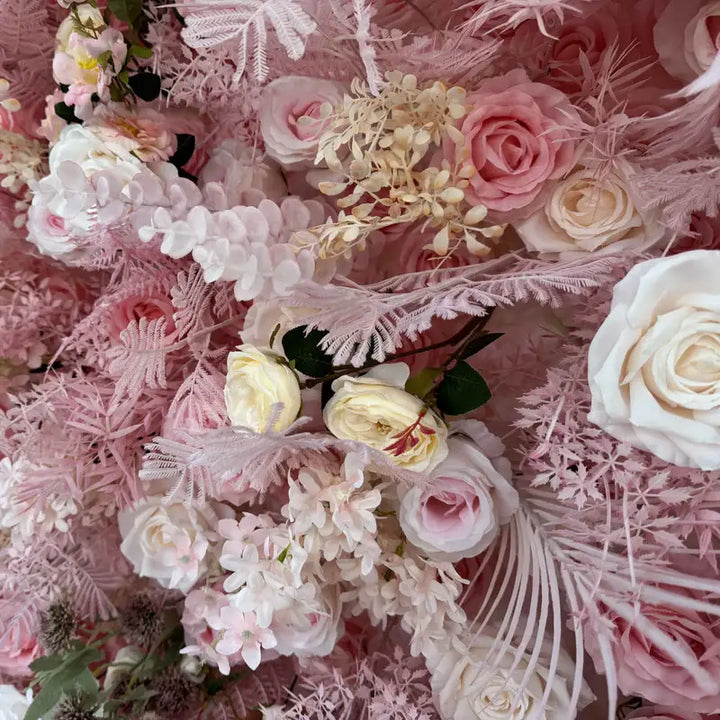 Close-up of decorative pink flower wall with varied blooms and textures.