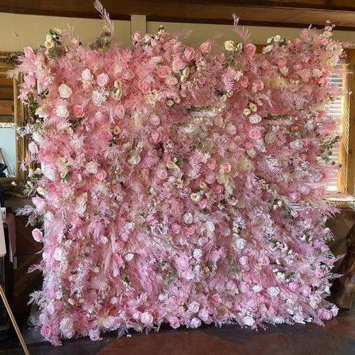 Pink floral wall backdrop rich with roses for weddings and parties.