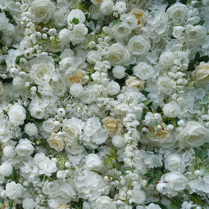 Close-up of white roses and soft cream florals on decorative backdrop