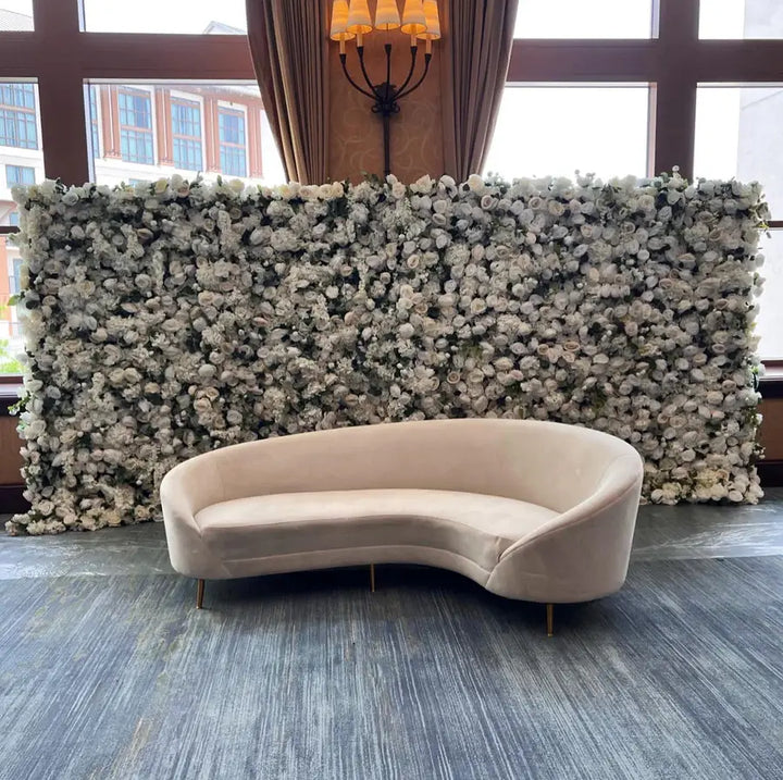 White floral wall backdrop behind modern indoor lounge setup