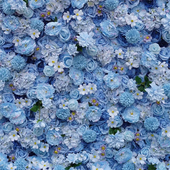 Close-up of soft blue roses, hydrangeas, and daisies on floral wall