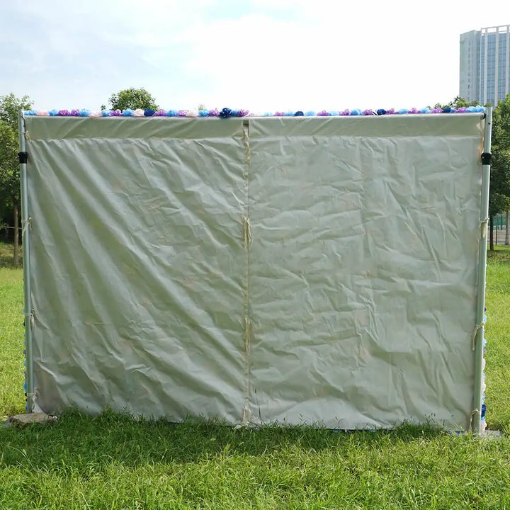 Rear view of flower wall backdrop with neutral fabric cover