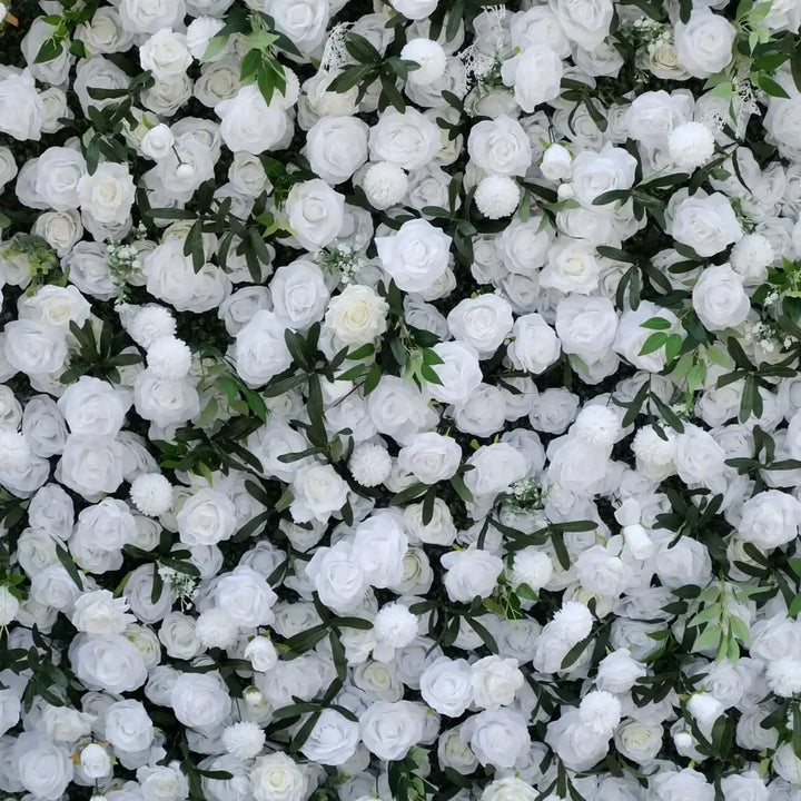 Textured shot of white roses, greenery, and soft accents on a floral backdrop.