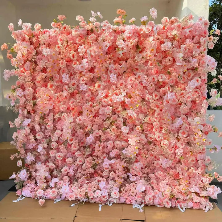 Romantic blush pink flower wall backdrop filled with roses and peonies for event decor.