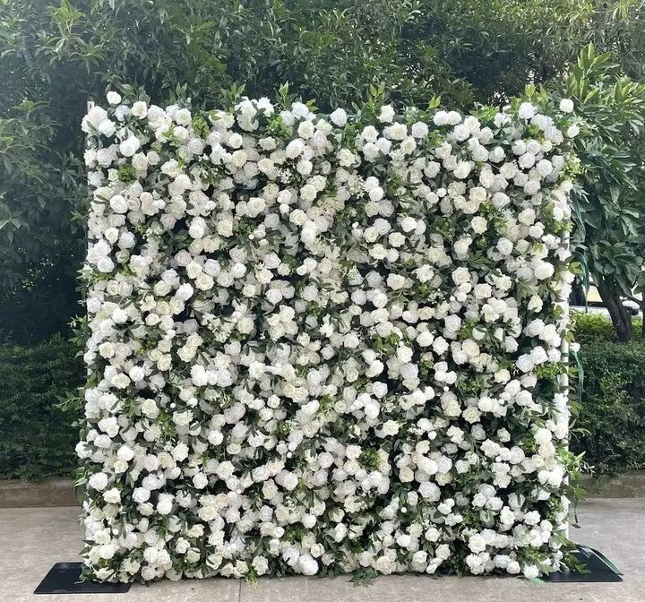 Textured shot of white roses, greenery, and soft accents on a floral backdrop.