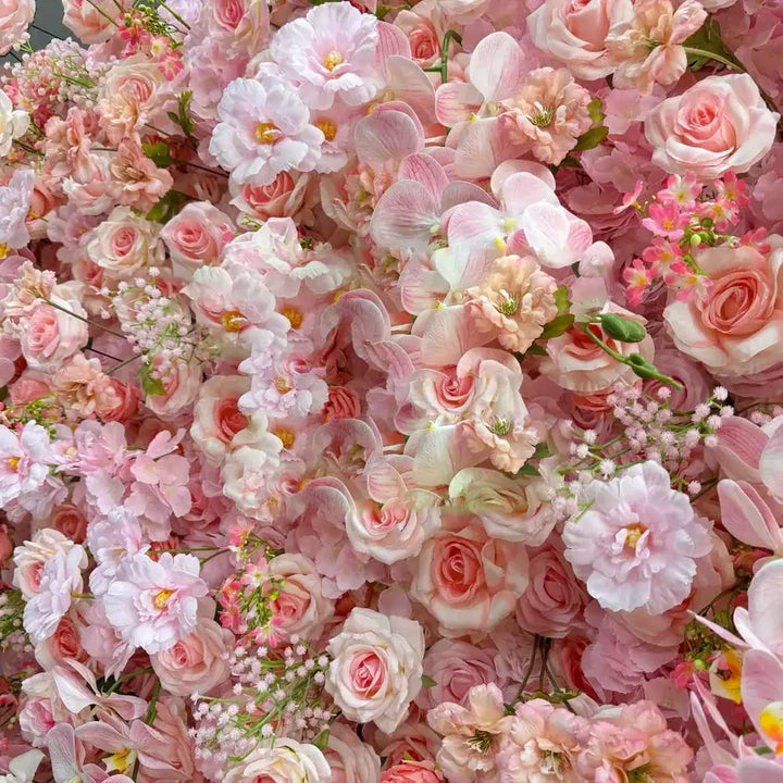 Close-up of soft pink floral backdrop with intricate flower arrangements for weddings.