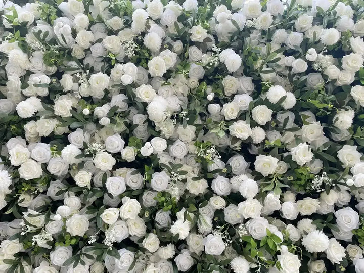 Close-up of a decorative white flower wall featuring lush roses and delicate greenery.