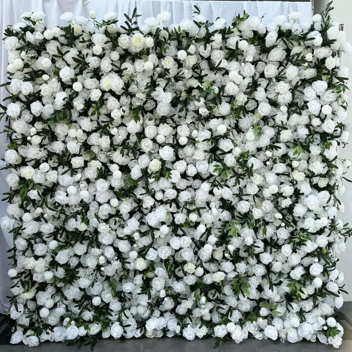Close-up of a decorative white flower wall featuring lush roses and delicate greenery.