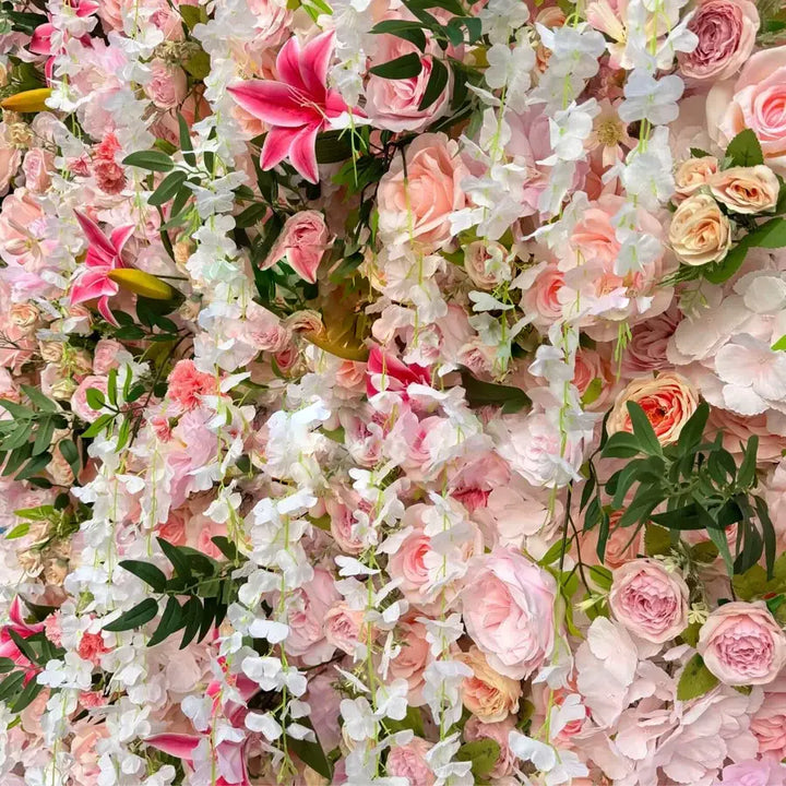 Lush decorative flower wall with pink flowers and greenery for elegant gatherings.