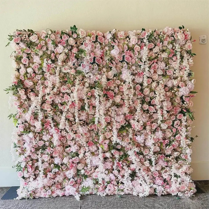 Lush decorative flower wall with pink flowers and greenery for elegant gatherings.