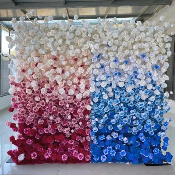 Full view of ombre flower wall backdrop featuring red, pink, white, and blue roses.