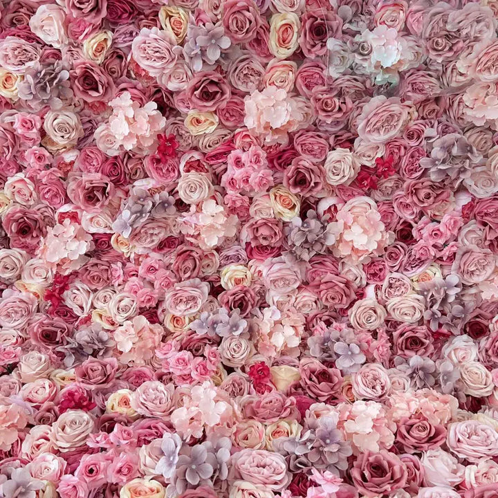 Dense arrangement of pink and mauve-toned flowers creating a romantic floral backdrop
