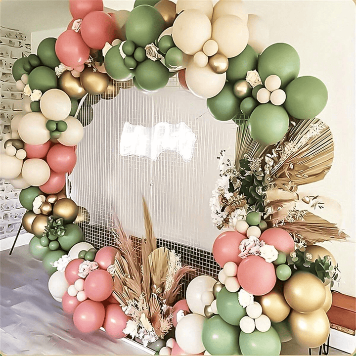 Rustic pink and green balloon arch with gold accents
