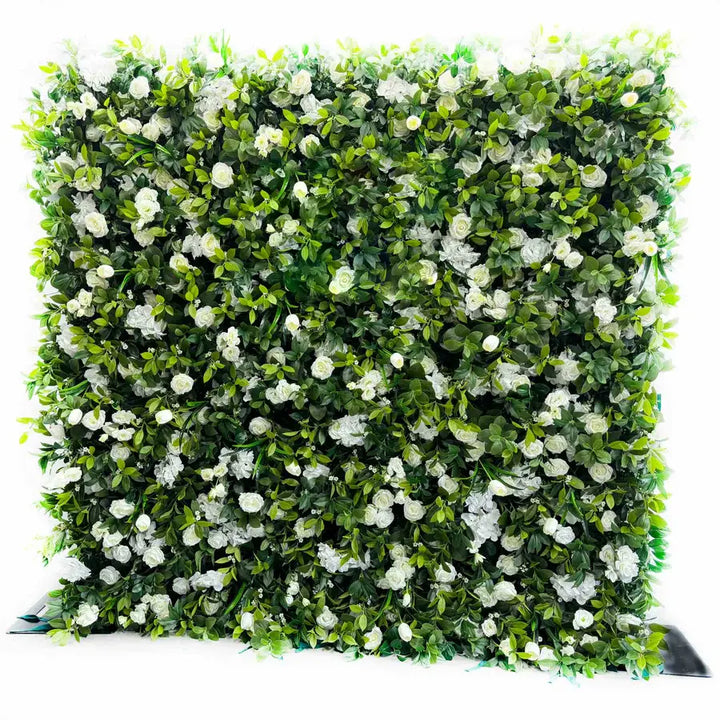 Lush green and white floral wall for outdoor events.