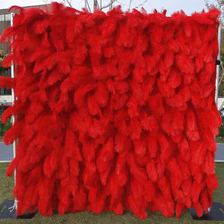 Close-up of soft red feathers layered densely for luxurious floral wall backdrop
