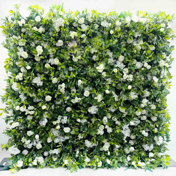 Close-up of white blooms on green leafy flower wall backdrop.