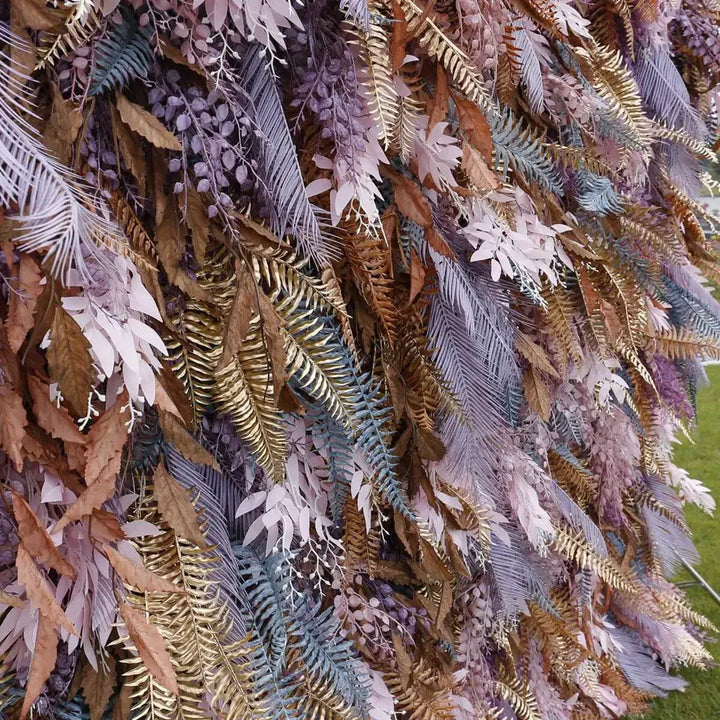 Close-up detail of layered foliage textures in dusty purple, gold, and blush tones