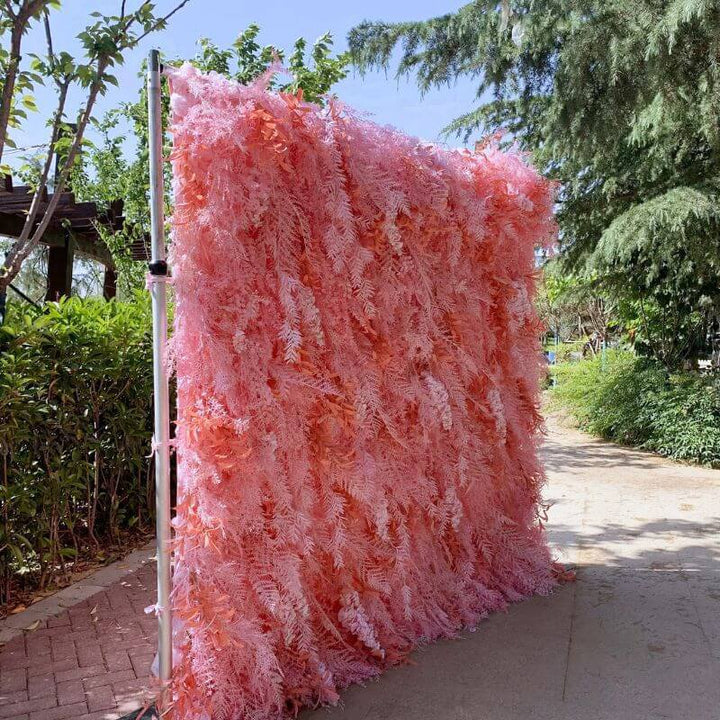 Vibrant pink decorative flower wall, providing a stunning backdrop for photos at events.