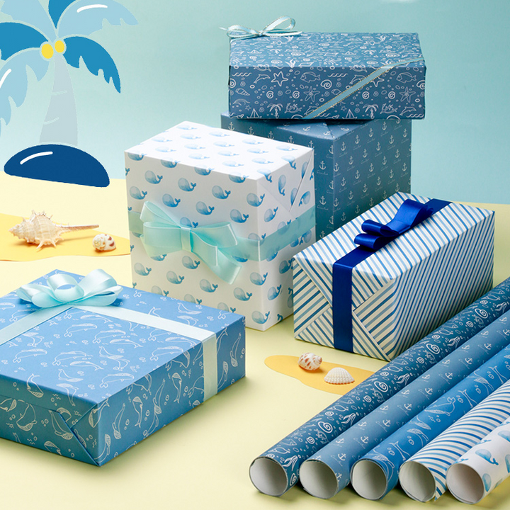 Ocean life wrapping paper for gifts, including whales and anchors.