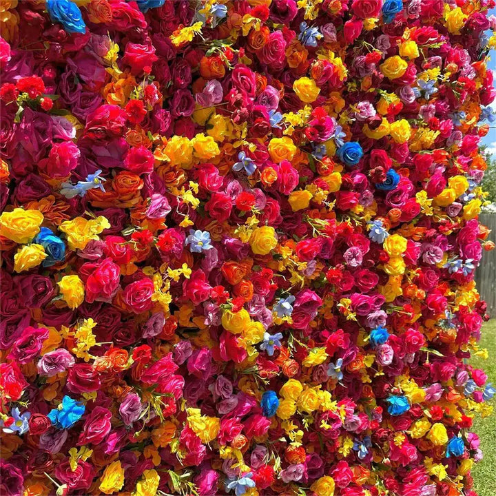 Close-up detail of mixed color roses and small accent flowers in a vivid floral backdrop
