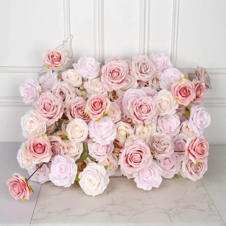 Close-up of soft pink artificial rose flowers arranged on a marble table