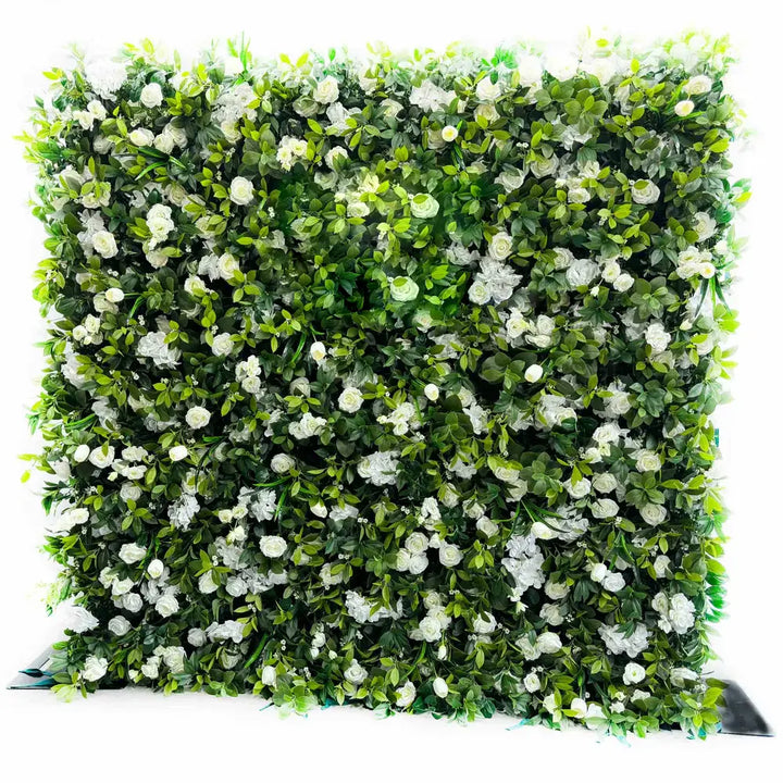 Close-up of white roses and lush greenery on decorative flower wall