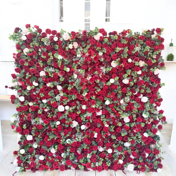 Deep red rose flower wall backdrop with greenery
