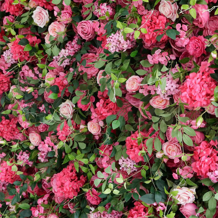 Close-up detail of roses, leaves, and pink wildflowers in a vibrant floral backdrop