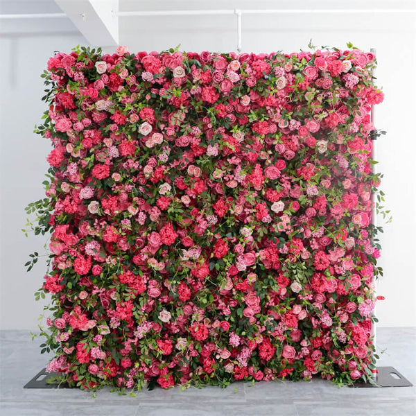Full view of pink rose and green foliage flower wall in bright studio lighting