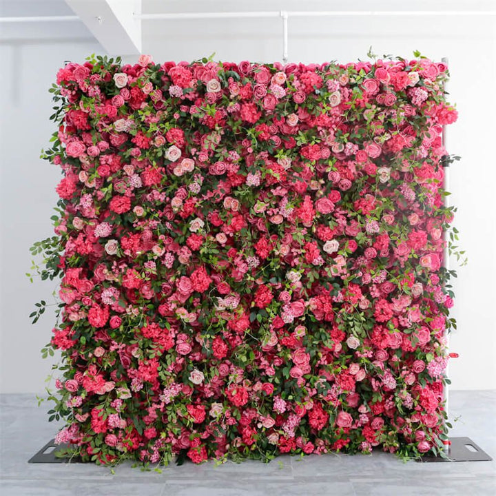 Full view of pink rose and green foliage flower wall in bright studio lighting