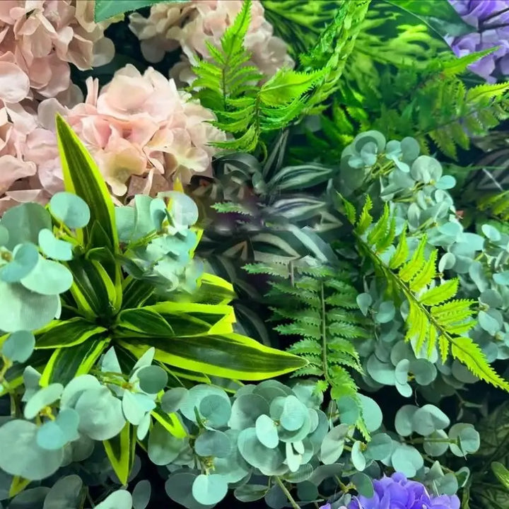 Detailed view of a flower wall with pink, purple, and red blooms, enhancing event aesthetics.