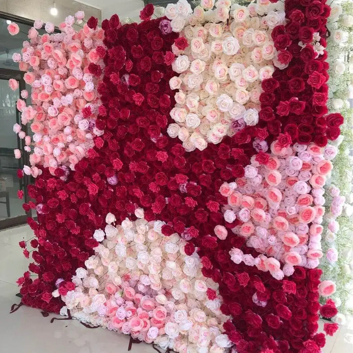 Wedding flower wall featuring red and blush blooms in modern pattern