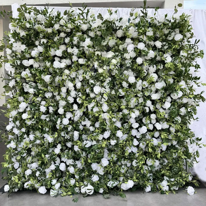 Full frontal view of a white rose and greenery flower wall backdrop