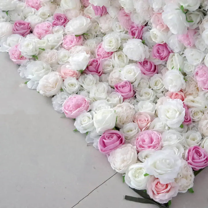 Close-up of white and blush roses arranged in decorative flower wall