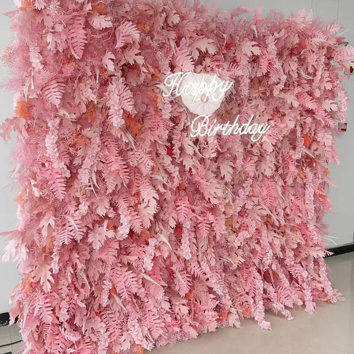 Birthday party flower wall with fluffy pink texture and foliage accents