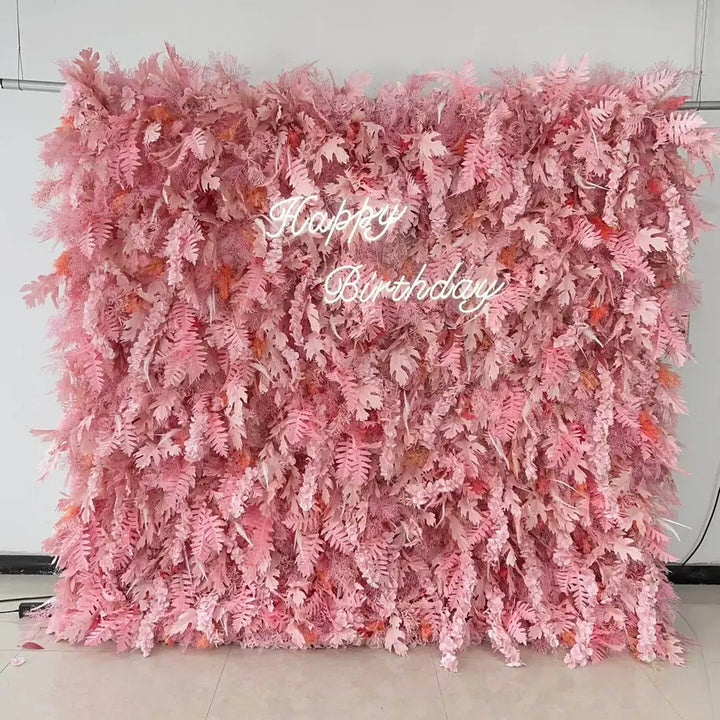Pink fern flower wall backdrop with “Happy Birthday” neon sign