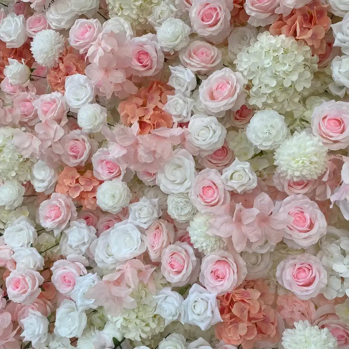 Zoomed-in view of white and soft pink roses with textured petals in floral backdrop.