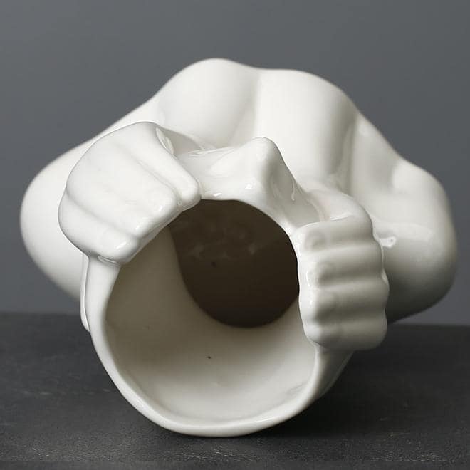Sculptural Nordic ceramic face vase with floral arrangement