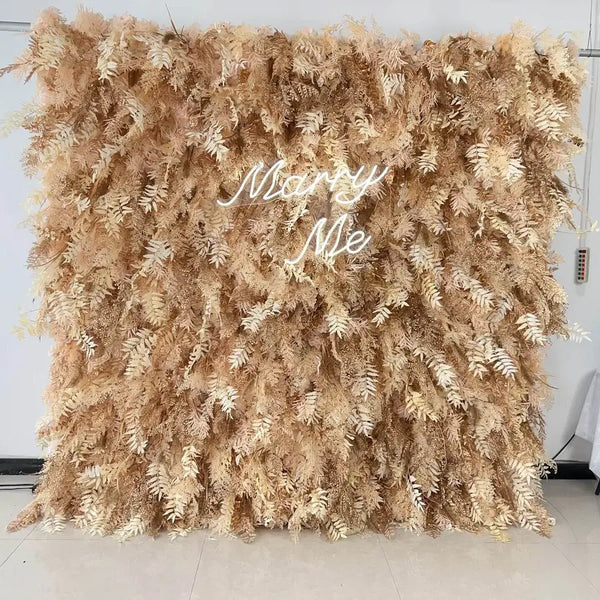 Neutral dried fern flower wall backdrop with “Marry Me” neon sign