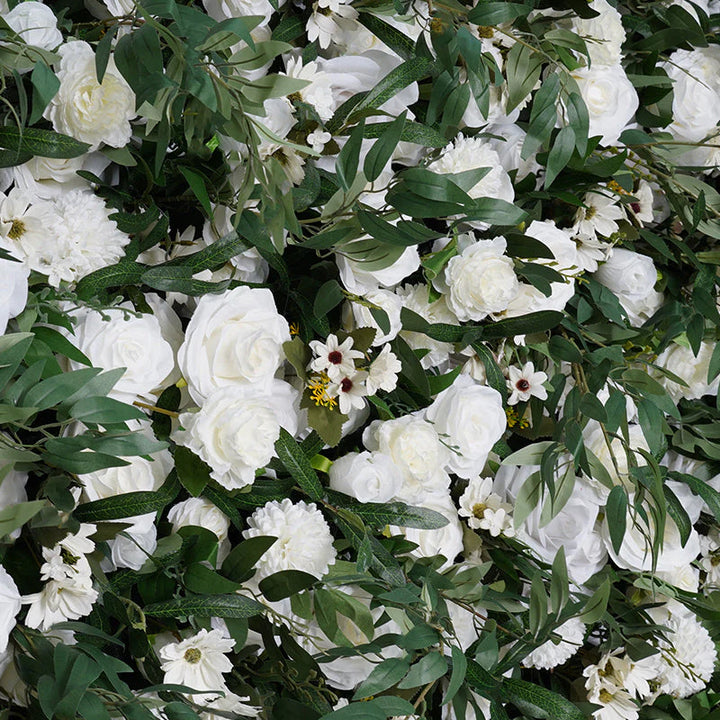 Pristine white roses and hydrangeas on a green leafy backdrop.
