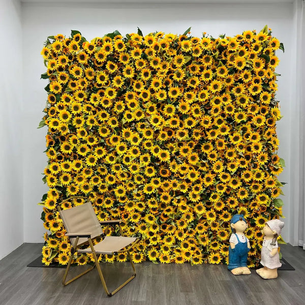 Bright sunflower flower wall with chair and figurines in front.