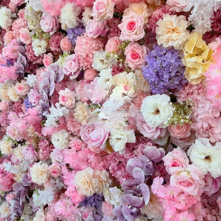 Detailed view of decorative flower wall with various shades of pink and white flowers for parties