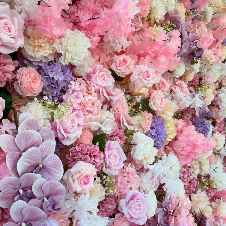 Detailed view of decorative flower wall with various shades of pink and white flowers for parties