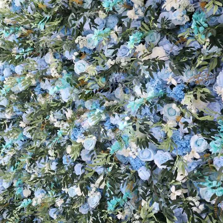 Decorative flower wall backdrop featuring blue roses and greenery for events.